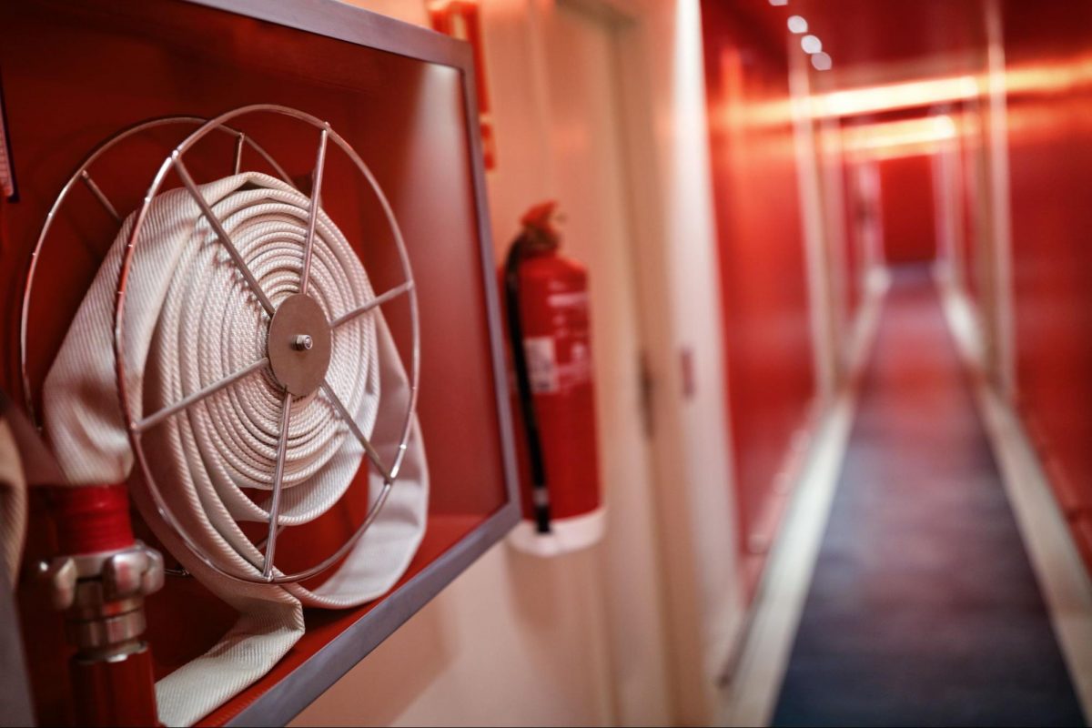 Fire hose in a building hallway that was built in after gaining a fire safety certificate in Singapore.