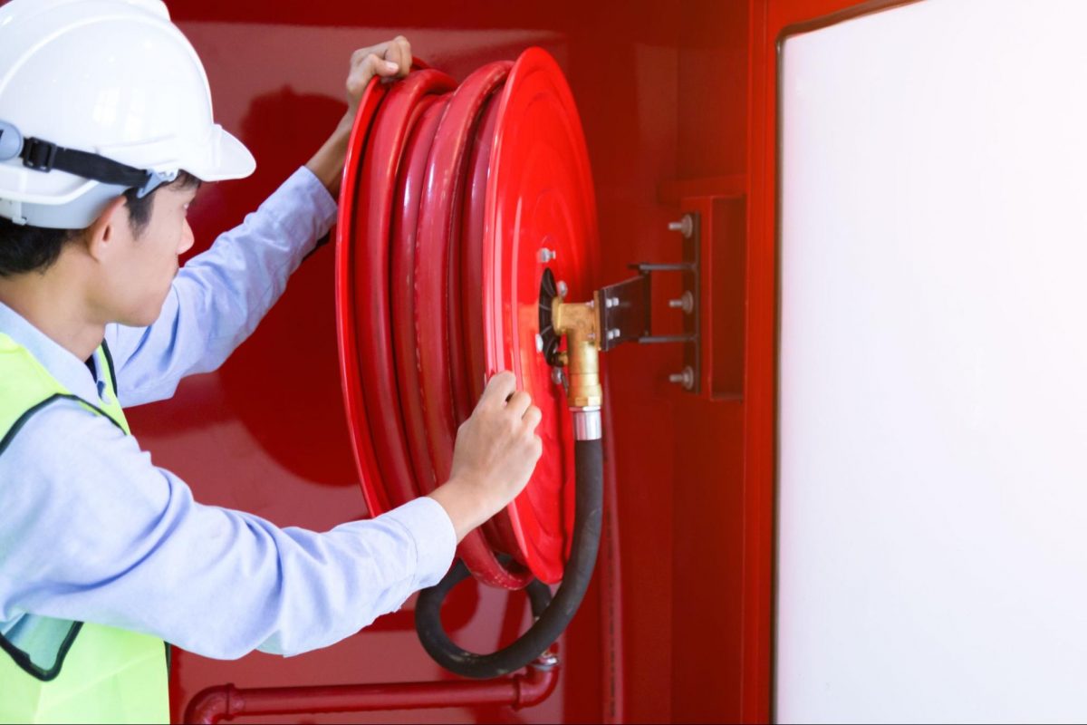 A QP checking if everything is in place under the SCDF fire safety guidelines.